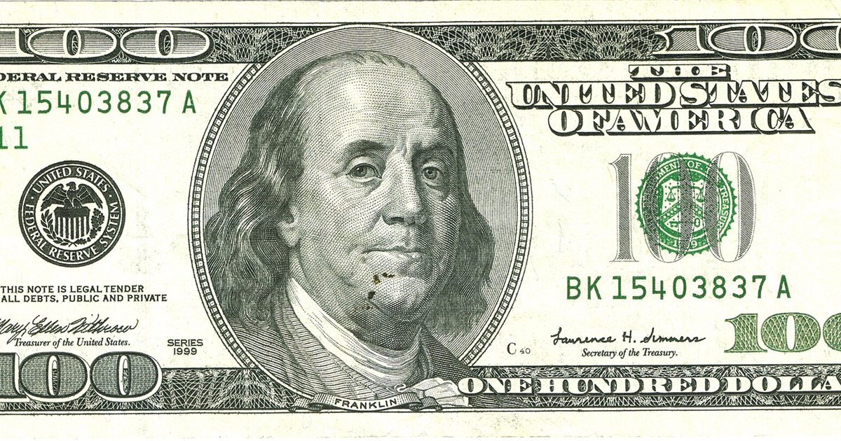 Close-up of a US one hundred dollar bill showing Benjamin Franklin