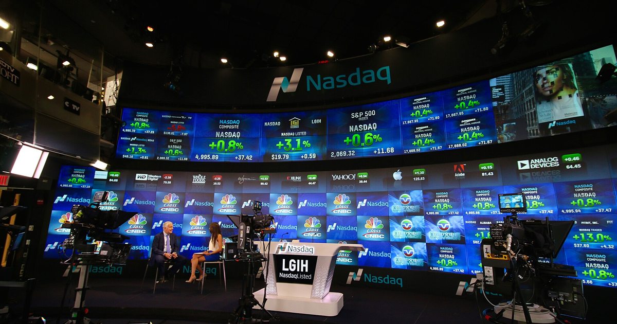 The Nasdaq MarketSite broadcast studio in Times Square, with a curved wall of screens showing stock prices
