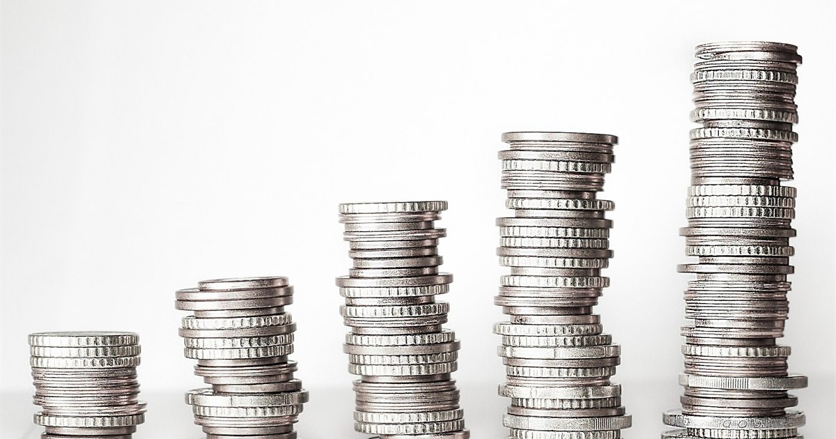 Stacks of coins of increasing height on a white background