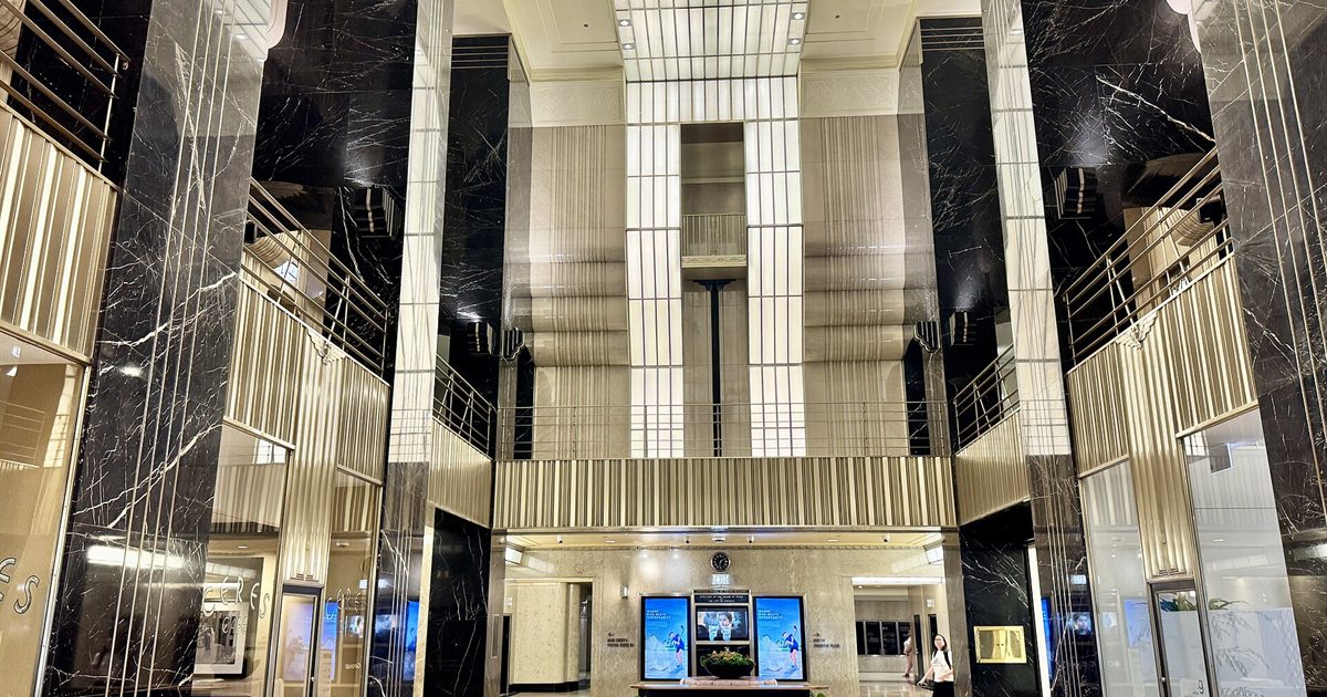 The Art Deco lobby of the Chicago Board of Trade Building, with black marble columns and gold-toned metalwork