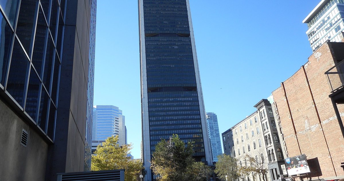 The dark glass Tour de la Bourse in Montreal, home of the Montréal Exchange where Canadian options trade, seen from street level