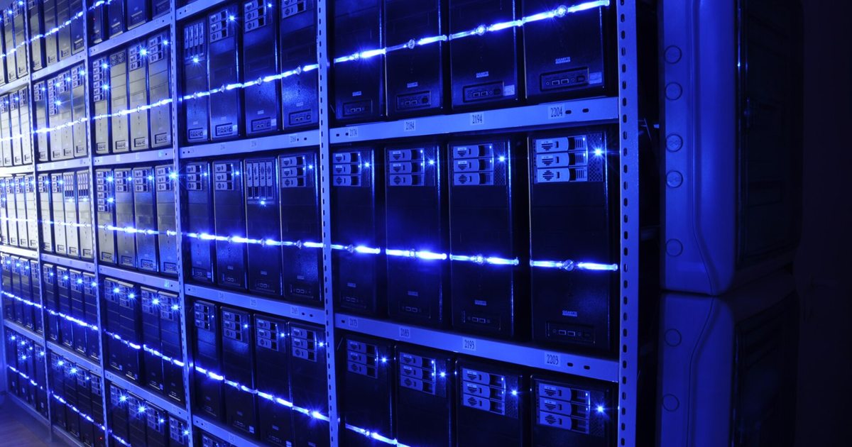 Rows of server racks lit in blue inside a data centre