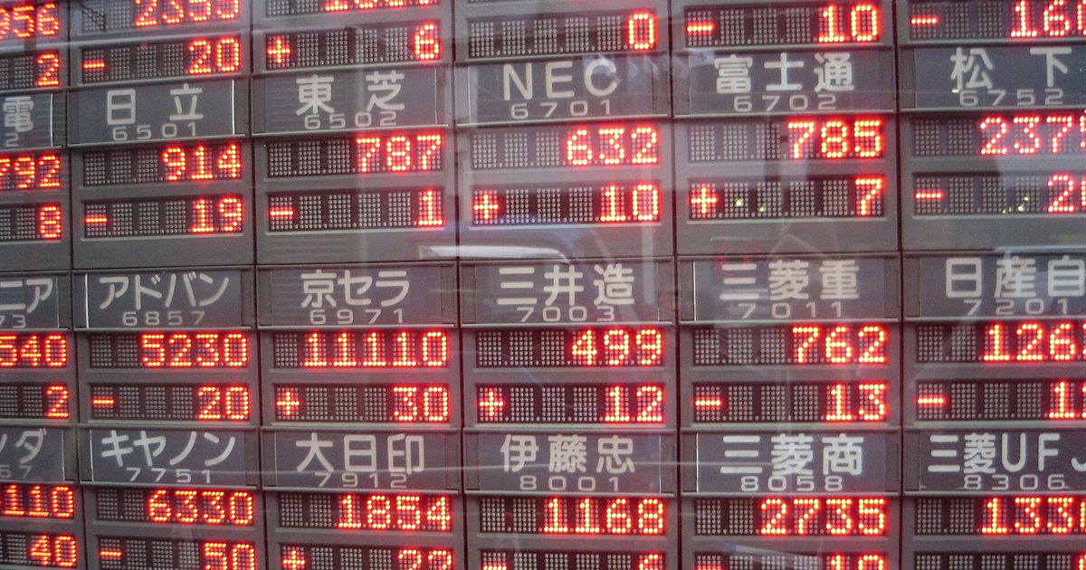 An electronic stock price board showing Japanese company share prices in Tokyo