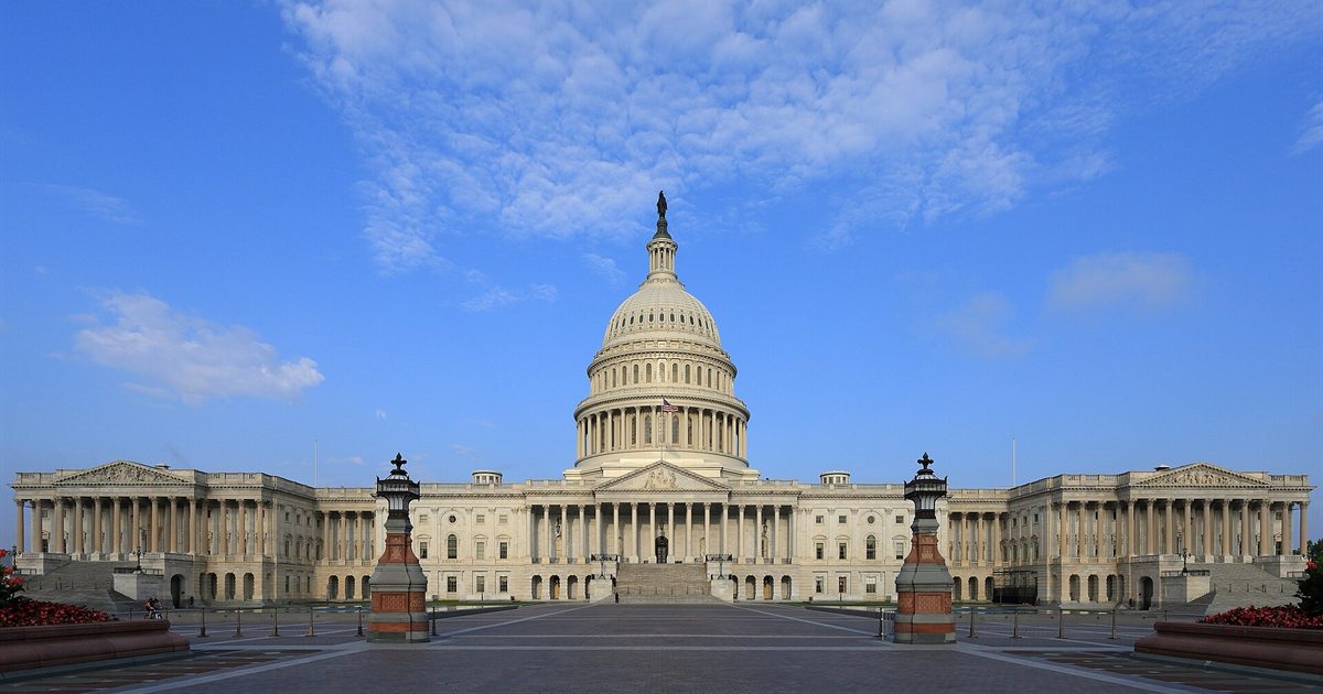 The east front of the United States Capitol in Washington, DC under a blue sky