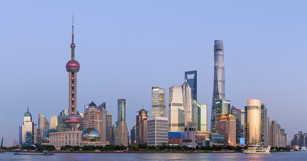 The Shanghai skyline in Pudong at dusk, with the Oriental Pearl Tower and Shanghai Tower