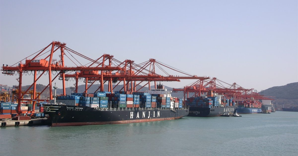 Container ships and red cranes at the port of Busan, South Korea