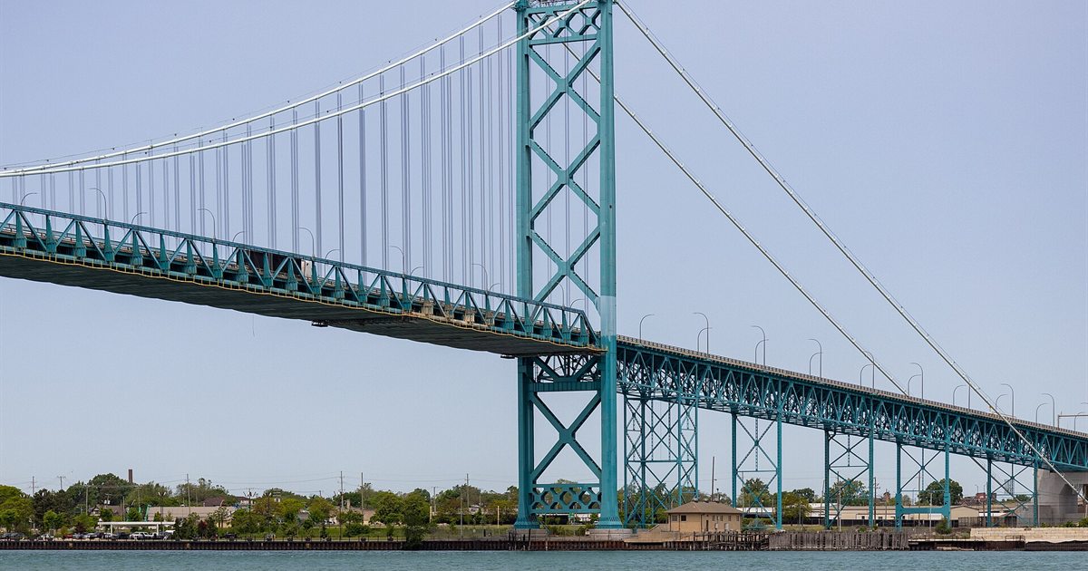The green steel Ambassador Bridge spanning the Detroit River between Windsor, Ontario and Detroit