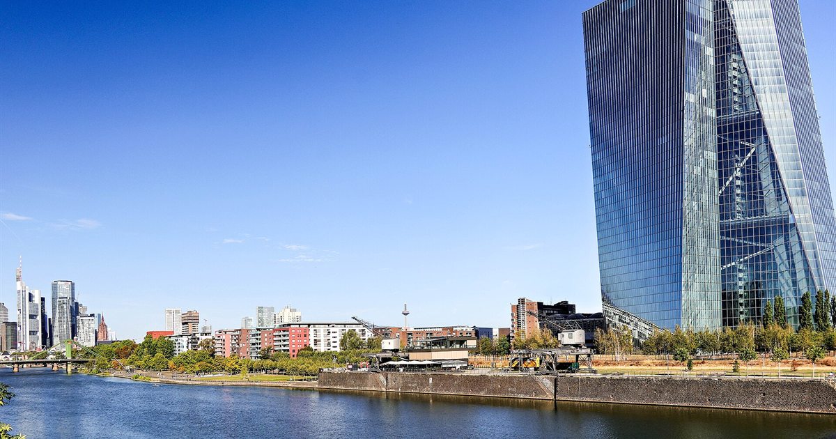 The European Central Bank's glass tower beside the River Main in Frankfurt under a clear blue sky