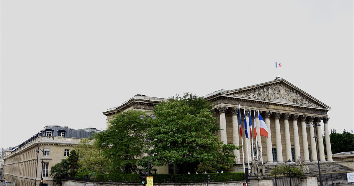 The Palais Bourbon, home of France's National Assembly, in Paris with French flags