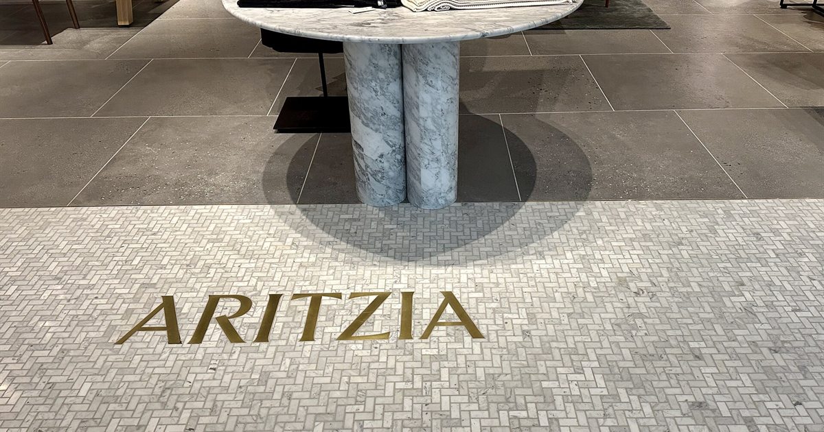 The Aritzia logo set into the stone floor at the entrance of its Dadeland Mall store in Miami
