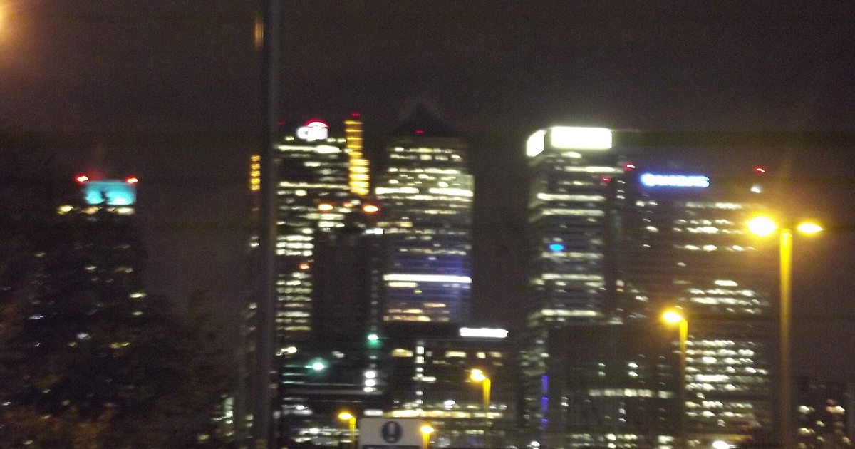 The Canary Wharf skyline in London at night, home to Barclays' headquarters