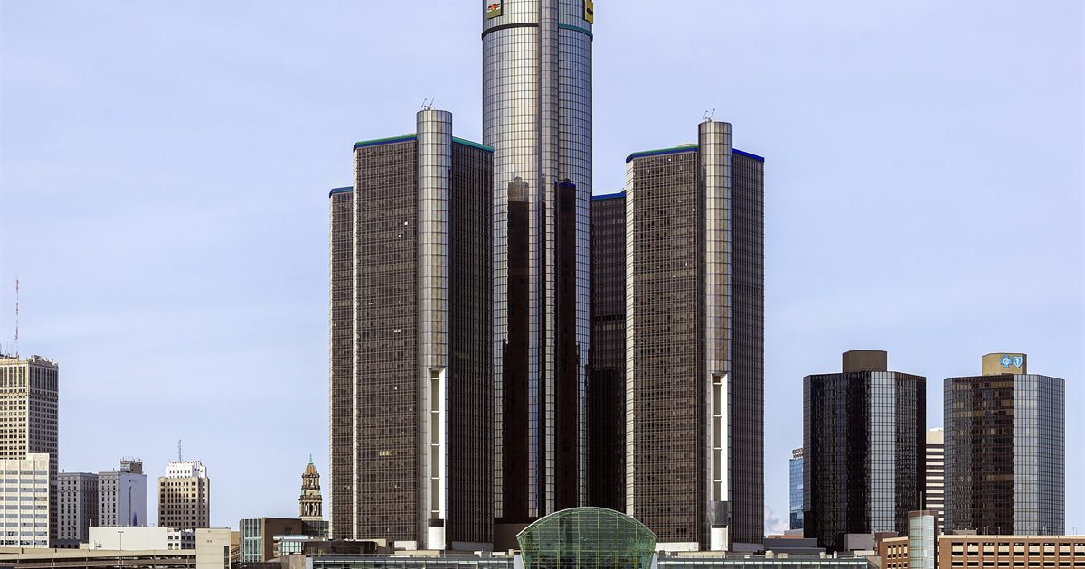 General Motors' Renaissance Center headquarters towers in Detroit against a blue sky