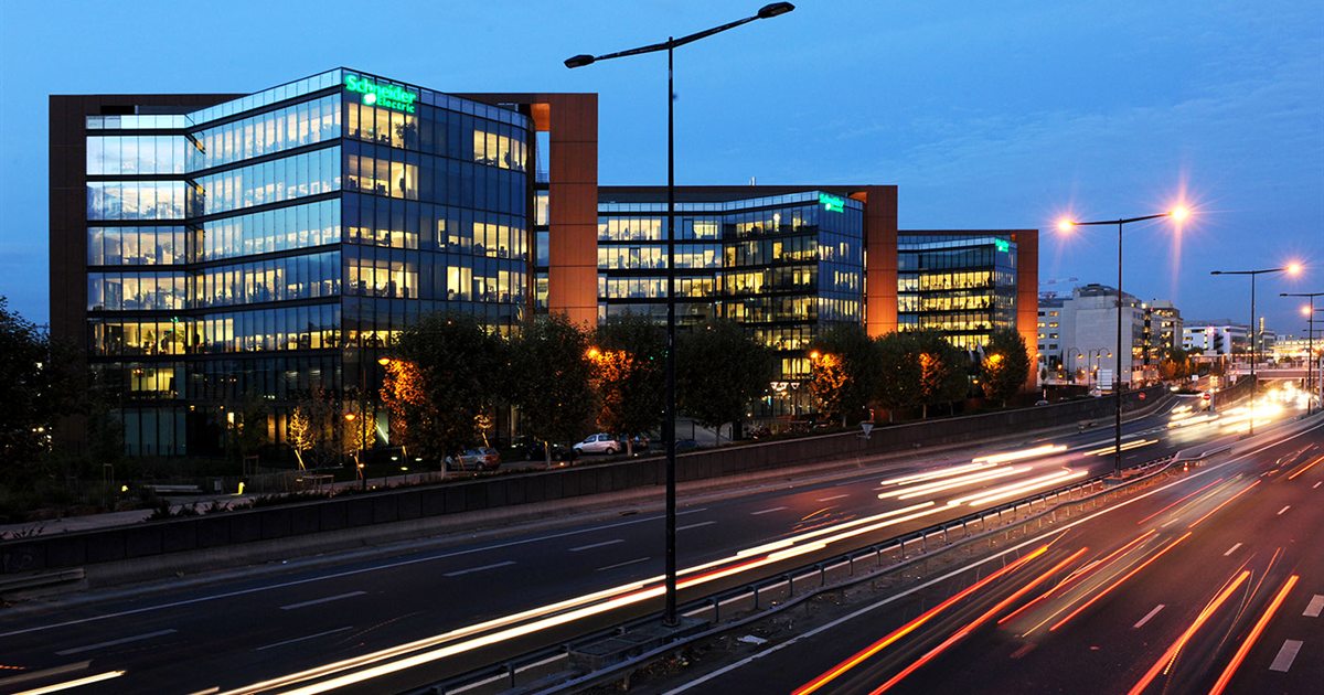 Schneider Electric's glass headquarters building in Rueil-Malmaison near Paris at dusk
