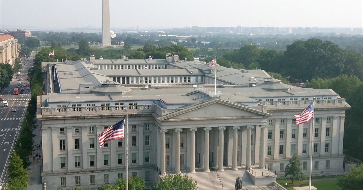 Aerial view of the US Treasury Building in Washington with the Washington Monument behind it