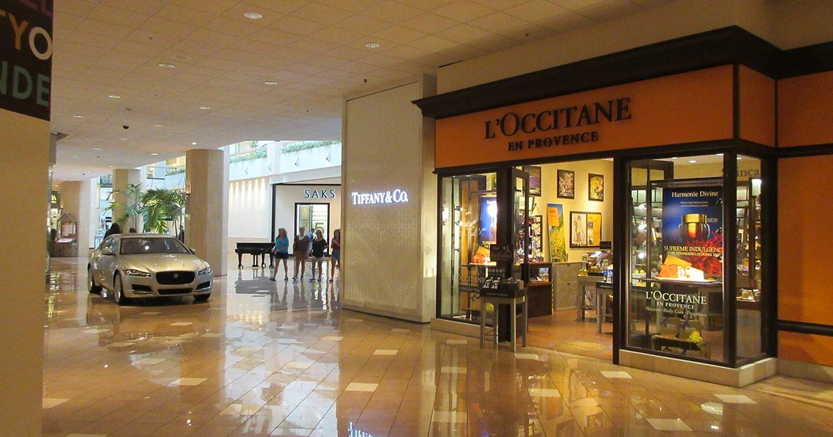 The interior of Canal Place shopping mall in New Orleans with polished floors and storefronts
